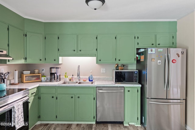 kitchen featuring sink, light hardwood / wood-style floors, extractor fan, appliances with stainless steel finishes, and ornamental molding