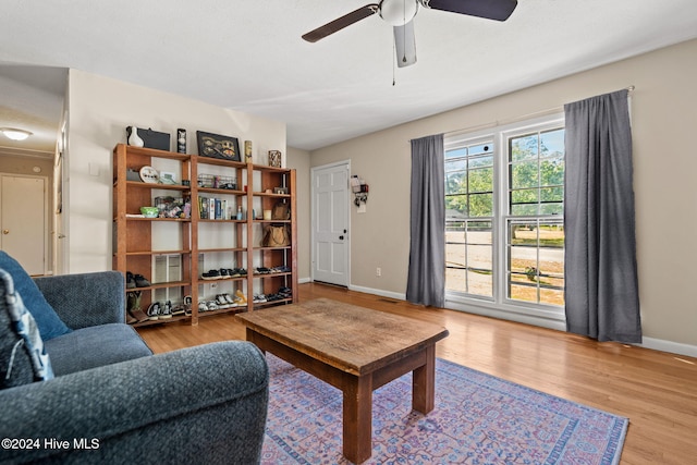 living room featuring ceiling fan and light hardwood / wood-style flooring