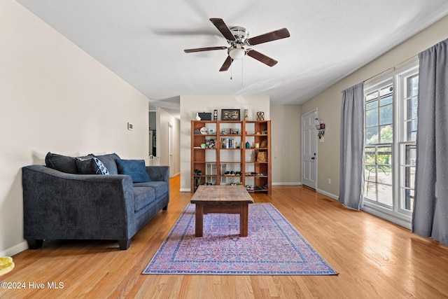 living room featuring light hardwood / wood-style floors and ceiling fan