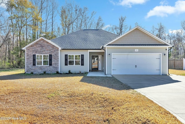 single story home with a front lawn and a garage