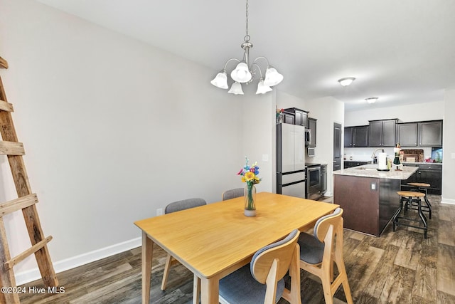 dining space with a notable chandelier and dark hardwood / wood-style flooring