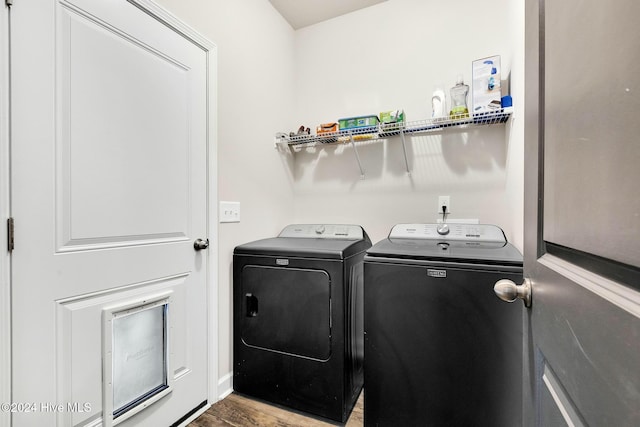 laundry area featuring separate washer and dryer and hardwood / wood-style flooring