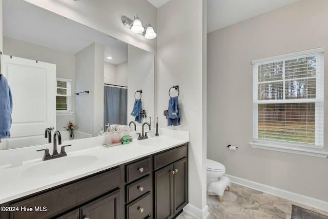 bathroom featuring walk in shower, vanity, and toilet