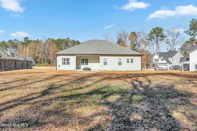 rear view of property featuring a yard