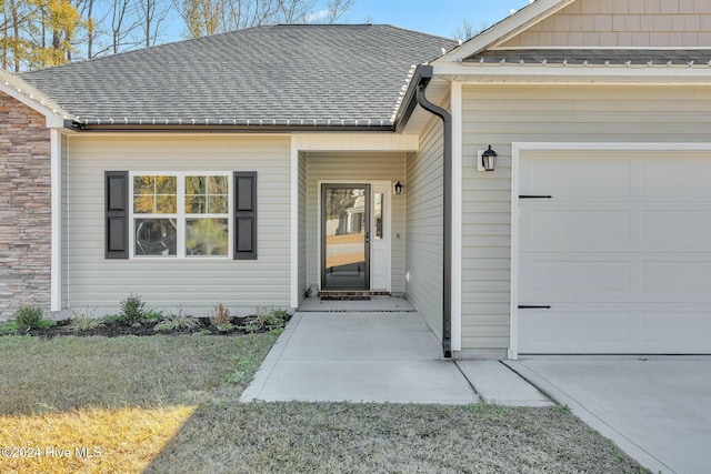 doorway to property featuring a garage