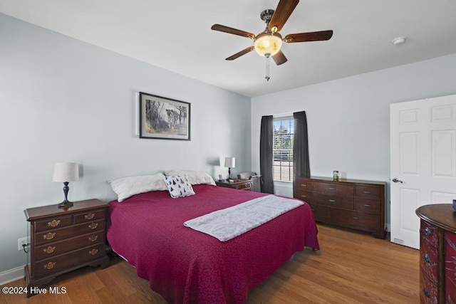 bedroom with ceiling fan and light hardwood / wood-style floors