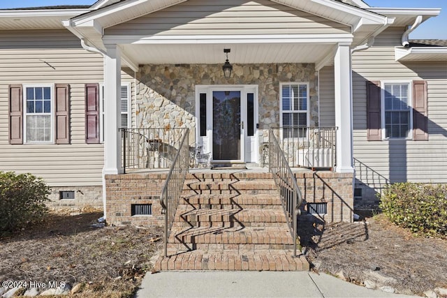 entrance to property featuring covered porch