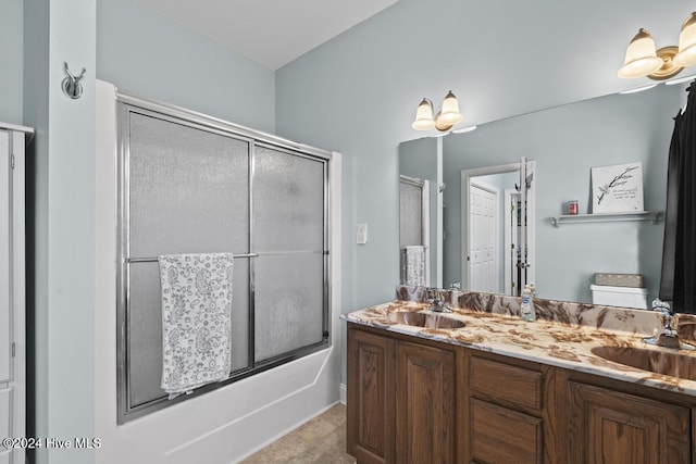 bathroom featuring shower / bath combination with glass door and vanity