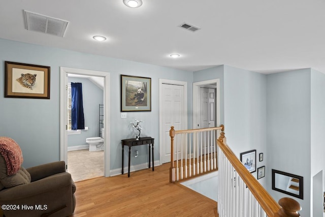 hall with light hardwood / wood-style floors