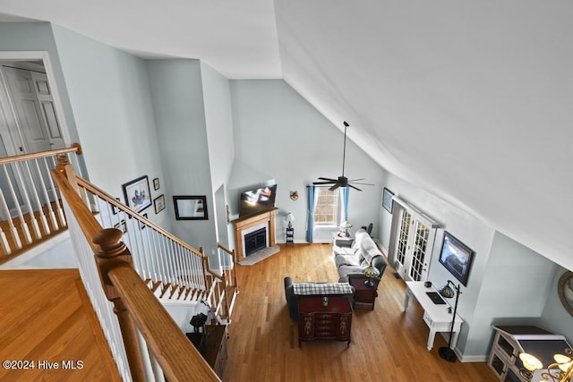 living room with ceiling fan, wood-type flooring, and high vaulted ceiling