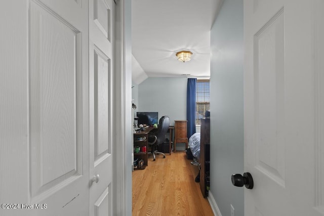 office with lofted ceiling and wood-type flooring