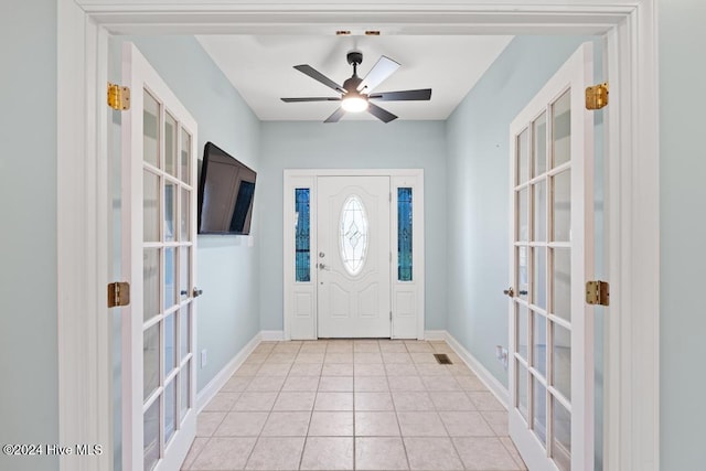 entryway with light tile patterned floors, french doors, and ceiling fan