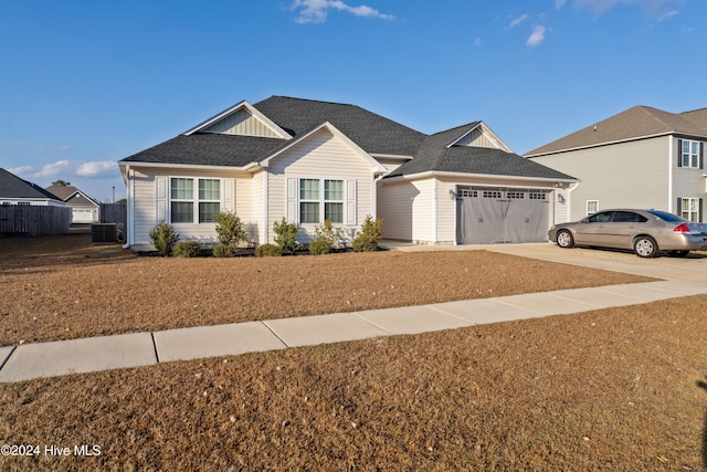 view of front of house with a garage and central air condition unit