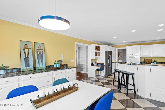 dining room with dark wood-type flooring and ornamental molding