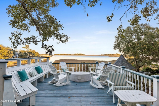 deck featuring outdoor lounge area and a water view