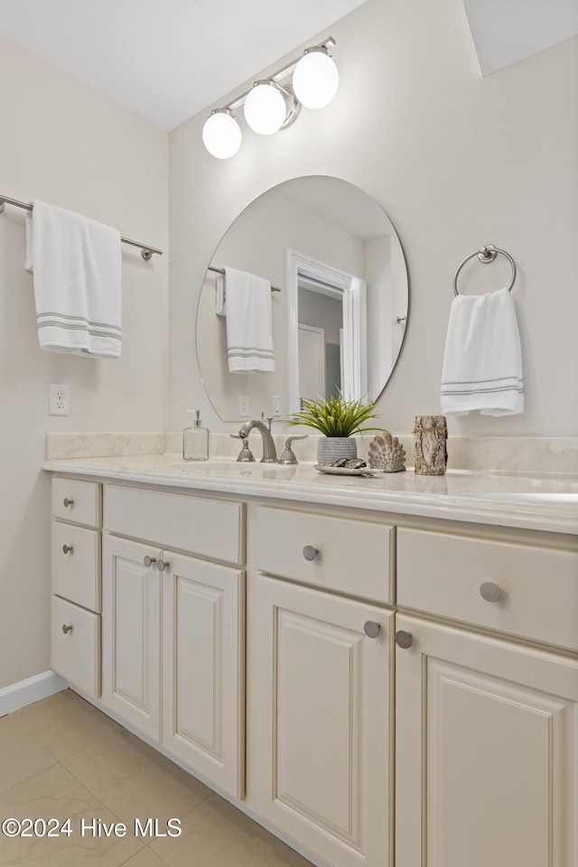 bathroom with tile patterned flooring and vanity