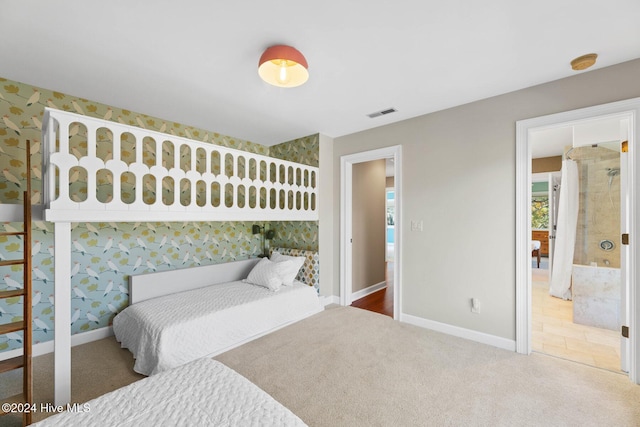 bedroom featuring carpet floors and ensuite bathroom