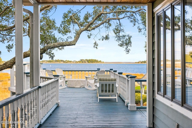 wooden terrace featuring a water view