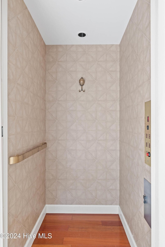 bathroom with hardwood / wood-style floors