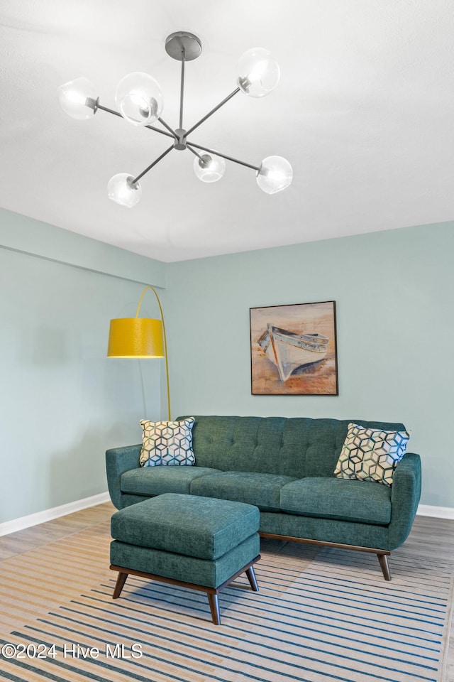 living room featuring hardwood / wood-style flooring and an inviting chandelier