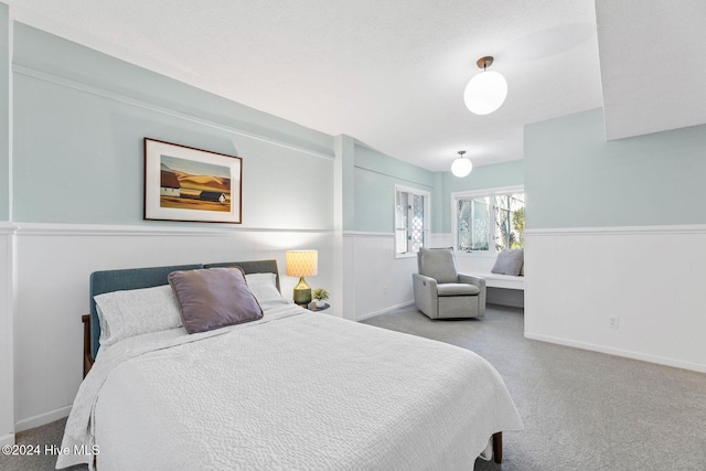 bedroom with light carpet and a textured ceiling