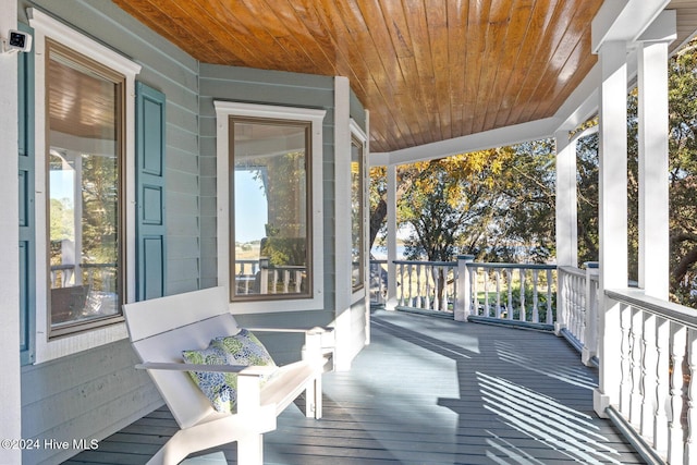 wooden terrace with a porch