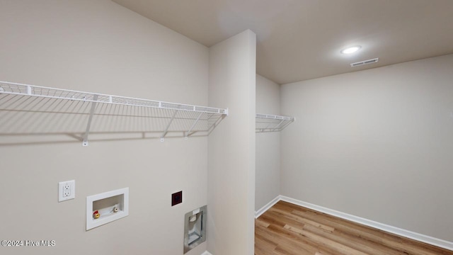 washroom with hookup for a washing machine and hardwood / wood-style flooring