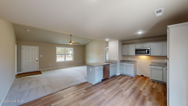 kitchen featuring kitchen peninsula, stainless steel appliances, ceiling fan, light hardwood / wood-style flooring, and white cabinetry