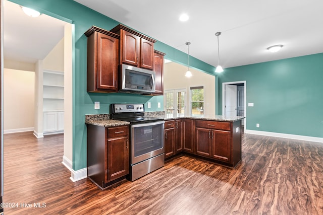 kitchen with decorative light fixtures, dark hardwood / wood-style floors, kitchen peninsula, and stainless steel appliances