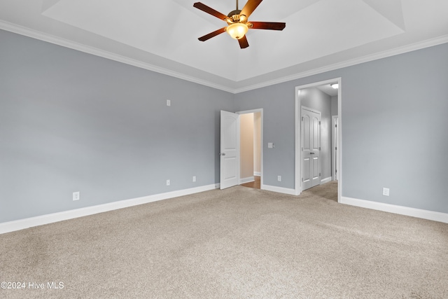 interior space featuring a tray ceiling, ceiling fan, and ornamental molding