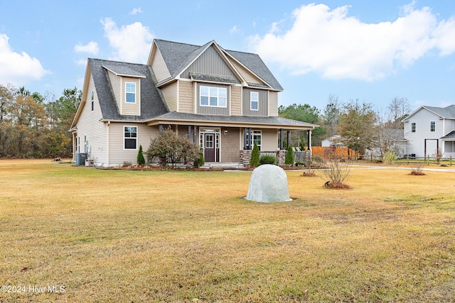 view of front of home featuring a porch, a front lawn, and cooling unit