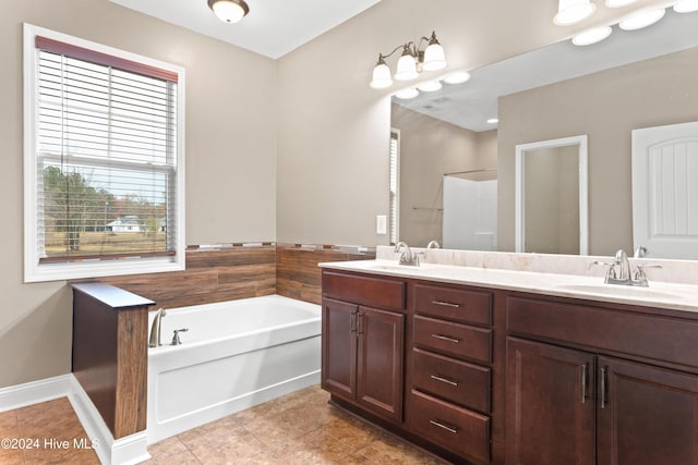 bathroom with tile patterned floors, separate shower and tub, and vanity