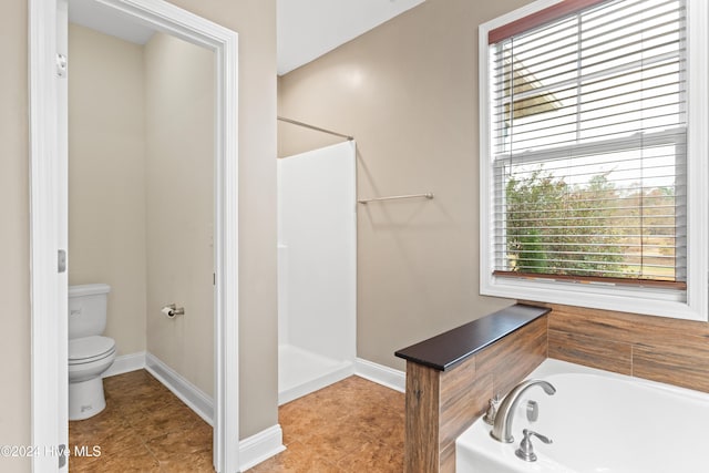 bathroom featuring plus walk in shower and toilet