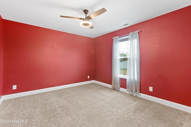 unfurnished room with ceiling fan and carpet floors