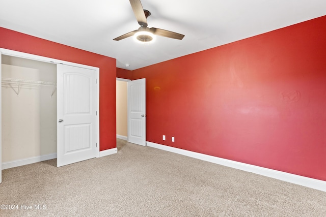 unfurnished bedroom featuring ceiling fan, a closet, and carpet floors