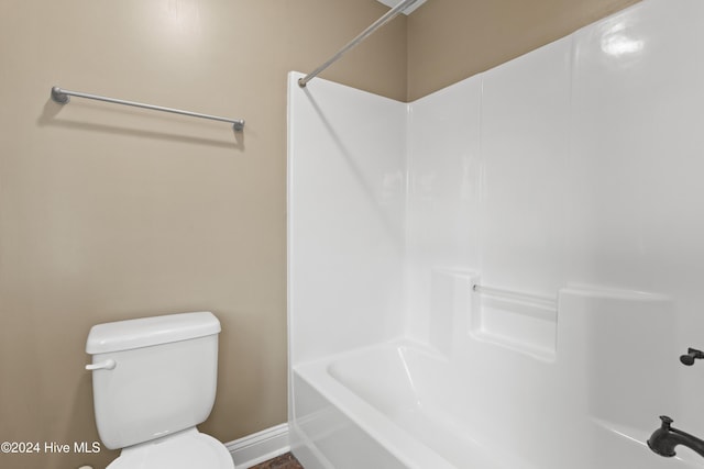 bathroom featuring shower / bath combination and toilet