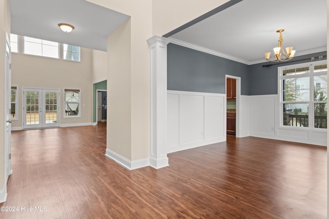 interior space featuring crown molding, french doors, dark hardwood / wood-style floors, and a notable chandelier