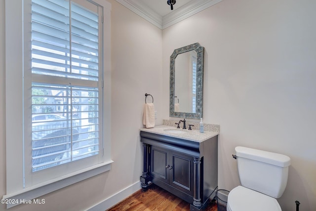 bathroom featuring vanity, hardwood / wood-style flooring, crown molding, and a healthy amount of sunlight