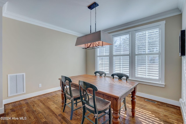 dining room with crown molding and wood-type flooring