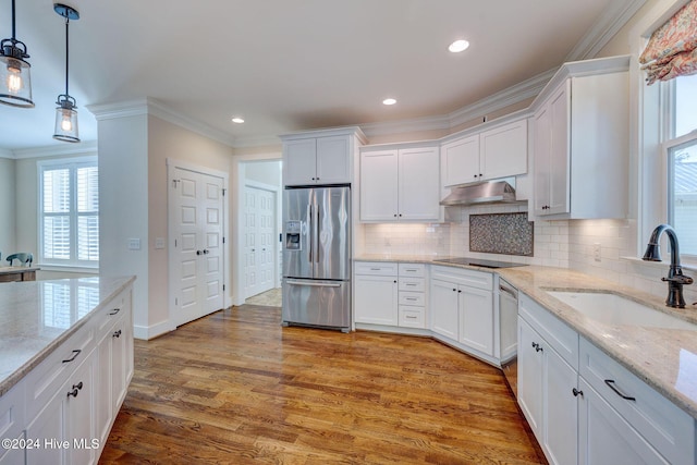 kitchen featuring hardwood / wood-style floors, appliances with stainless steel finishes, white cabinetry, and sink