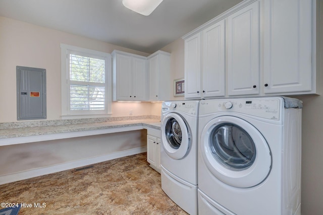 laundry area with electric panel, cabinets, and washer and dryer