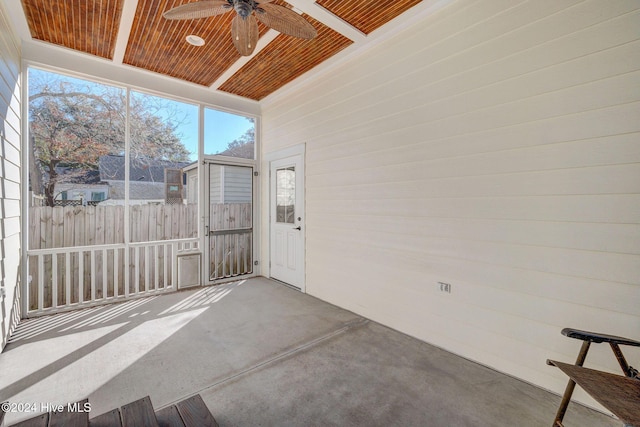 unfurnished sunroom with ceiling fan and wooden ceiling