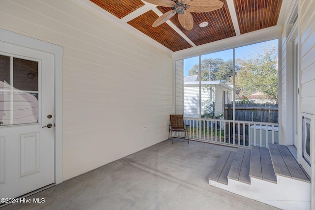 unfurnished sunroom featuring ceiling fan and wooden ceiling