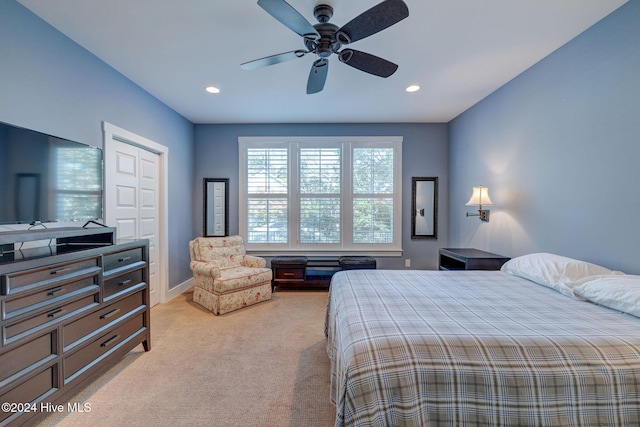 bedroom with light carpet, a closet, and ceiling fan