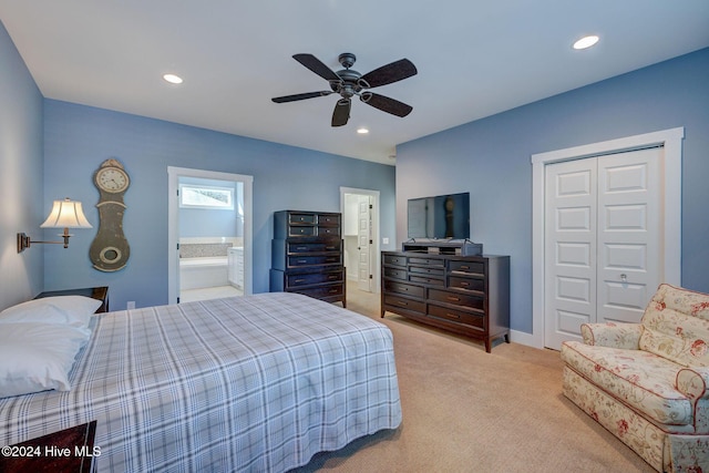 bedroom featuring ensuite bath, ceiling fan, a closet, and light carpet