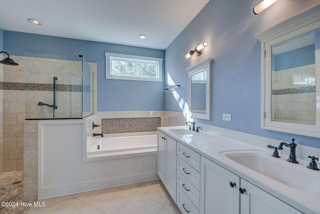 bathroom with tile patterned flooring, shower with separate bathtub, and vanity