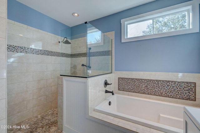 bathroom featuring vanity and shower with separate bathtub