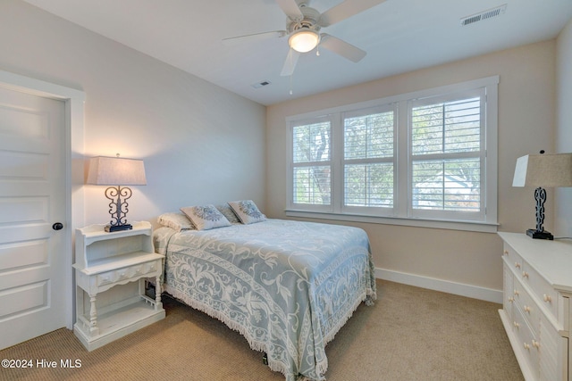 bedroom featuring light colored carpet and ceiling fan