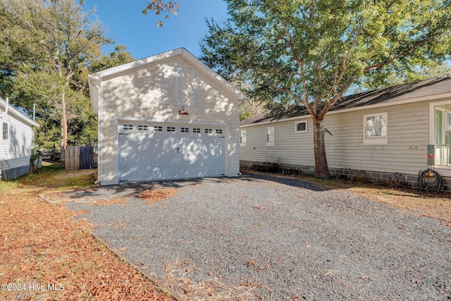 view of property exterior with a garage and an outdoor structure