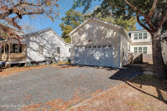 view of front of house featuring a porch, a garage, and an outdoor structure